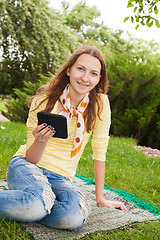 Image showing Teen girl reading electronic book