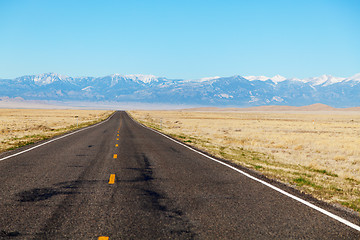 Image showing Empty freeway approaching mountains range