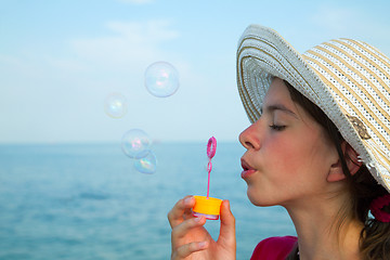 Image showing Teen girl blowing bubbles