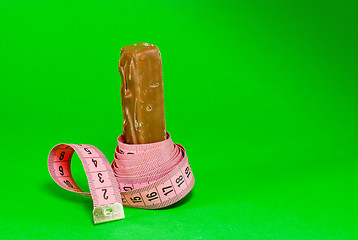 Image showing Chocolate bar with a pink metering tape