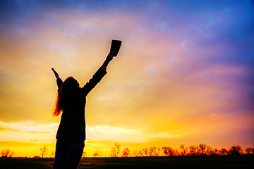 Image showing Woman staying with raised hands