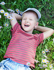 Image showing Small boy lying on the grass