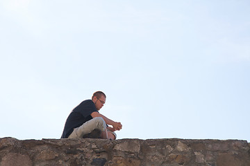 Image showing Young man sittting outdoors