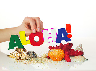 Image showing Female's hand holding colorful word 'Aloha'