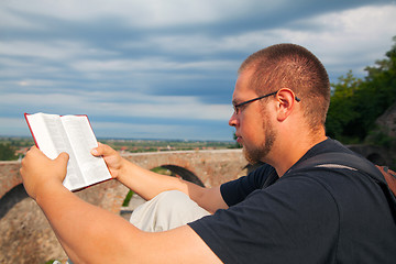 Image showing Young man reading the Bible