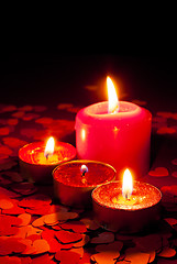 Image showing Four burning candles over red background