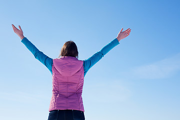 Image showing Teen girl staying with raised hands