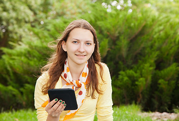 Image showing Teen girl reading electronic book