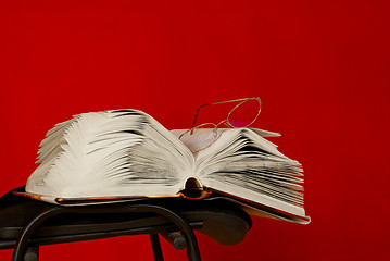 Image showing Open book laying on the chair 