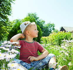 Image showing Small boy sitting on the grass
