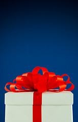 Image showing White box with present against blue background