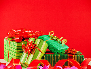 Image showing Wrapped boxes with presents against red background