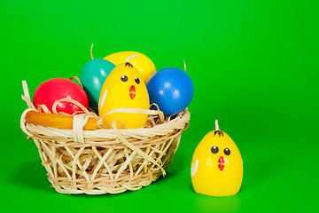 Image showing Basket with the Easter eggs and yellow chicken candle