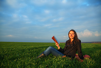 Image showing Teen girl reading the Bible outdoors