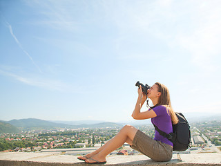 Image showing Young lady photographer outdoors