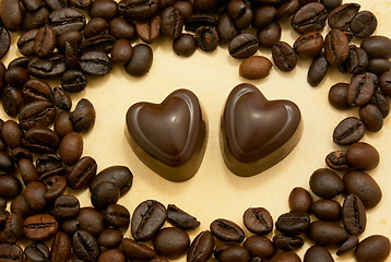 Image showing Two heart shaped chocolate candies and coffee beans