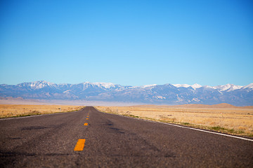 Image showing Empty freeway approaching mountains range