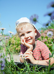 Image showing Small boy laying on the grass