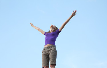 Image showing Young woman sitting with raised hand