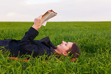 Image showing Teen girl reading the Bible outdoors