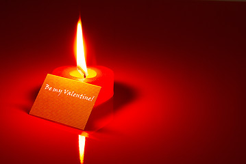 Image showing Burning heart shaped candle and a Valentine's card