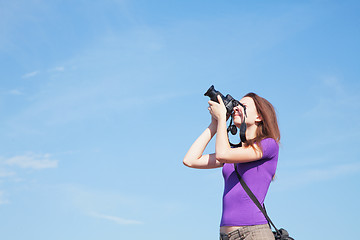 Image showing Young lady photographer outdoors