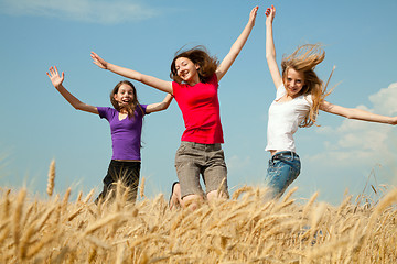 Image showing Teen girl jumping at a wheat field