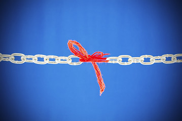 Image showing Broken chain connected with red threads 