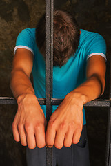 Image showing Man behind the bars
