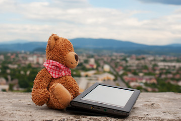 Image showing Electronic book reader laying outdoors