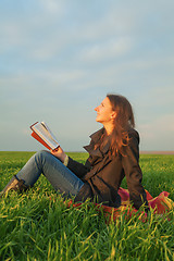 Image showing Teen girl reading the Bible outdoors