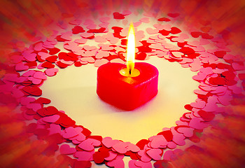 Image showing Burning red heart shaped candle