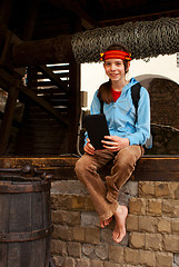 Image showing Teen girl with electronic book sitting outside