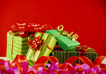 Image showing Wrapped boxes with presents against red background