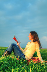 Image showing Teen girl reading the Bible outdoors