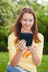 Image showing Teen girl reading electronic book