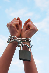 Image showing Hands tied up with chains