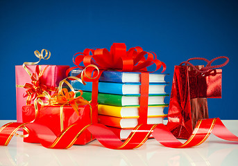 Image showing Christmas presents with stack of books