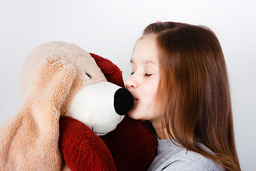 Image showing teen girl kissing a toy dog