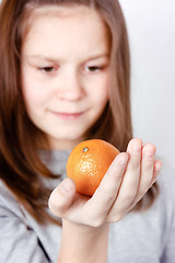 Image showing teen holding in the palm of mandarin