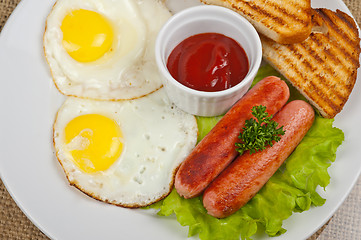 Image showing Fried eggs with sausages