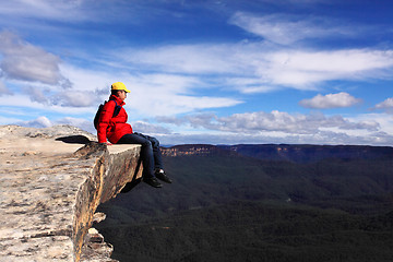 Image showing Sitting on Top of the World - hiker rests and admires views of B