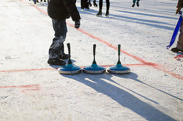 Image showing eisstock curling toys tool people play winter game 