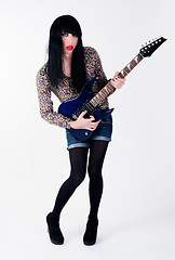 Image showing transvestite in heels with electric guitar