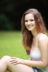 Image showing Portrait of a pretty teenage girl in a lush park