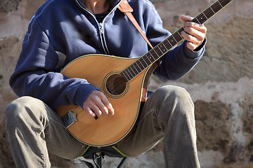 Image showing Man playing a mandolin