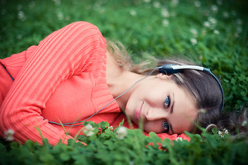 Image showing Relaxed young woman listening music