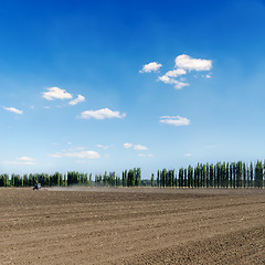 Image showing black ploughed field under blue sky