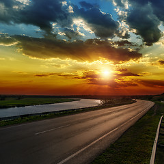 Image showing dramatic sunset over asphald road