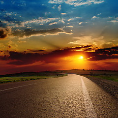 Image showing red dramatic sunset over asphalt road